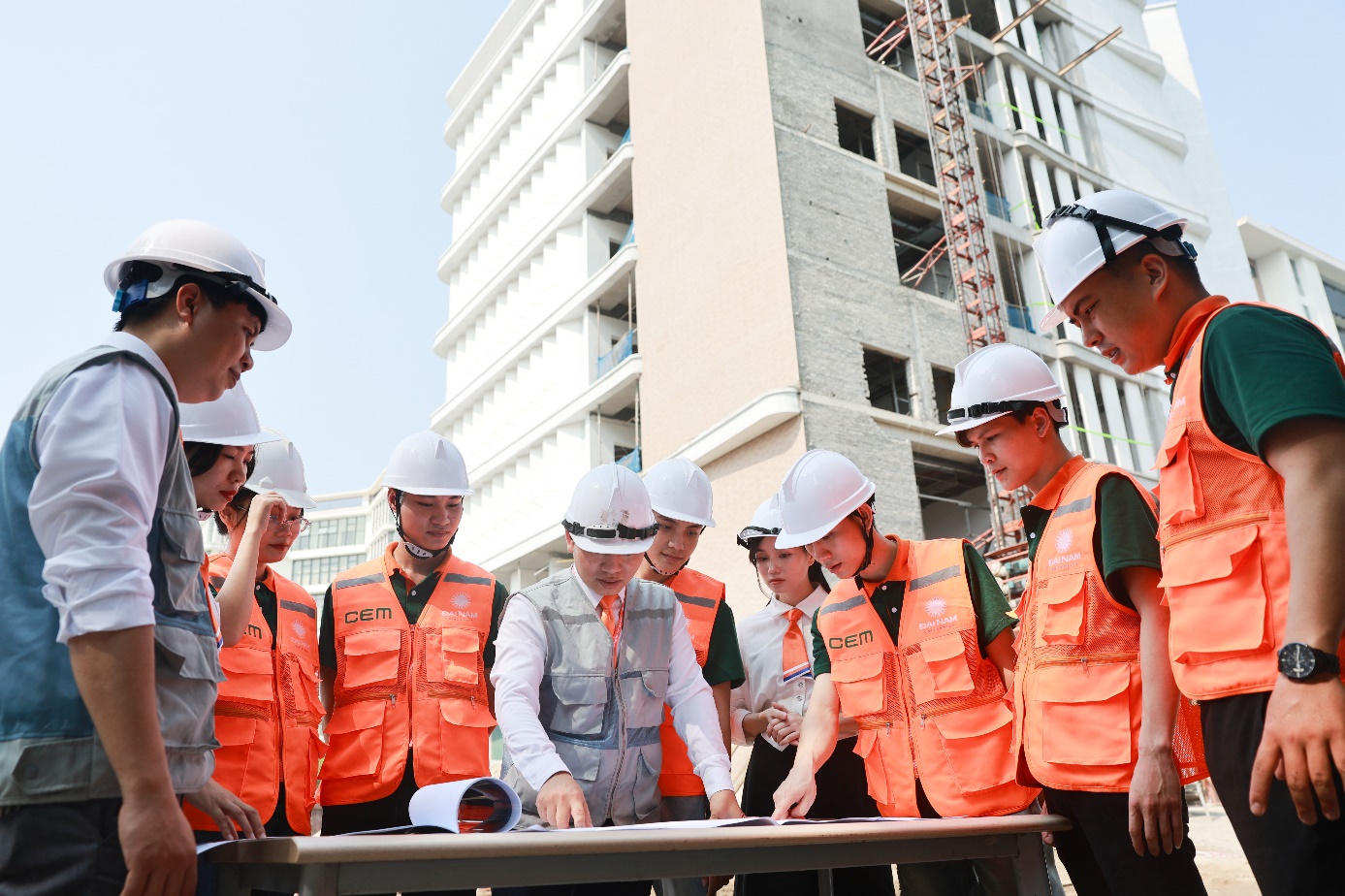 A group of people wearing helmets and vests  Description automatically generated