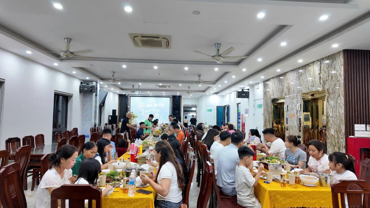 Du khách chung vui bữa cơm do chủ khách sạn mời. Ảnh: Thu Báu